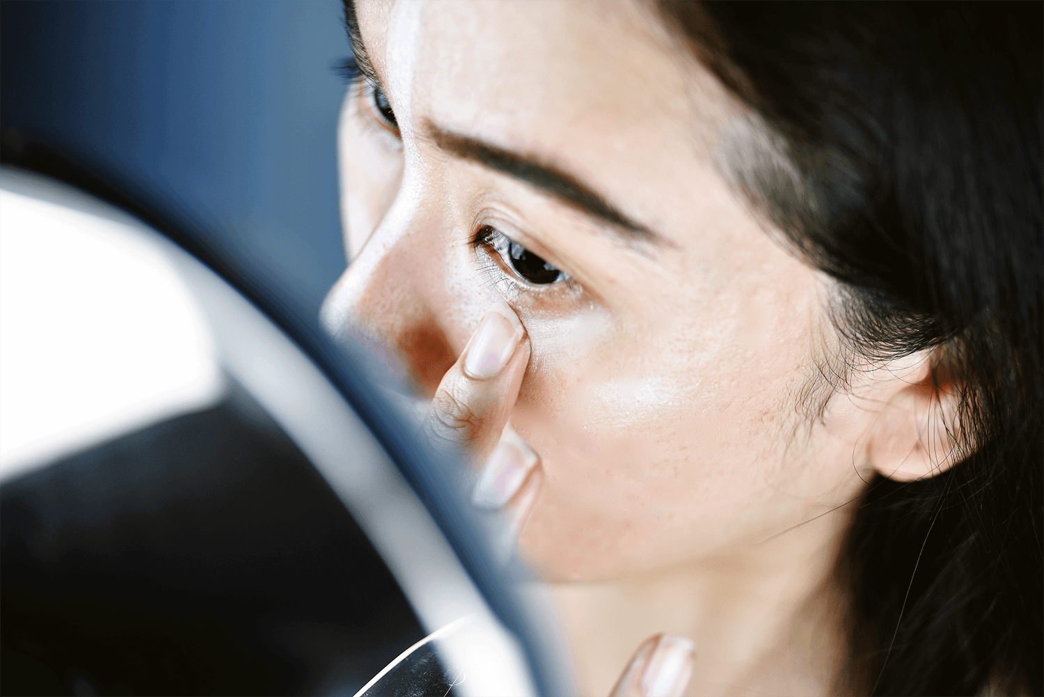 Asian Woman Applying Concealer Undereye