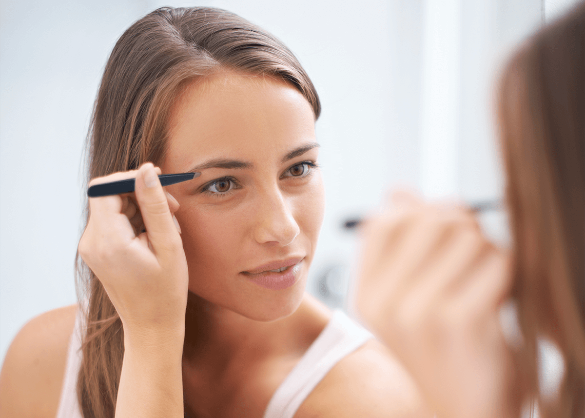 Beautiful Girl Plucking Eyebrows for High Arched Look