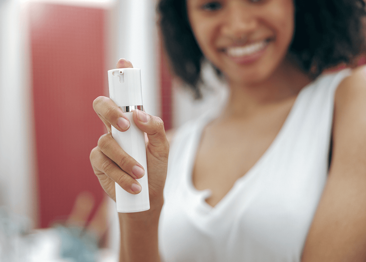 Closeup of Woman Standing at Bathroom Holding Makeup