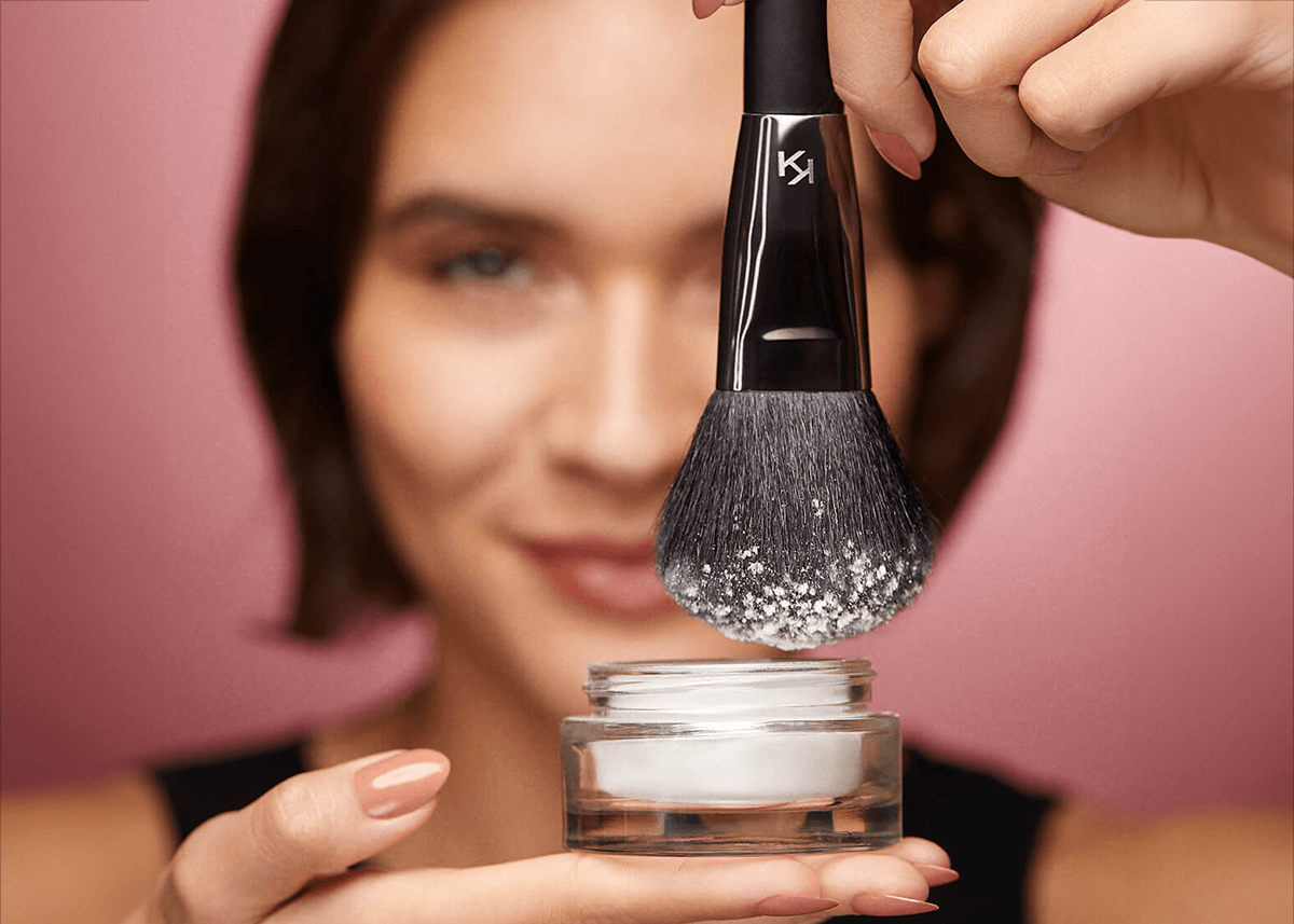 Woman holding Setting Powder on Brush