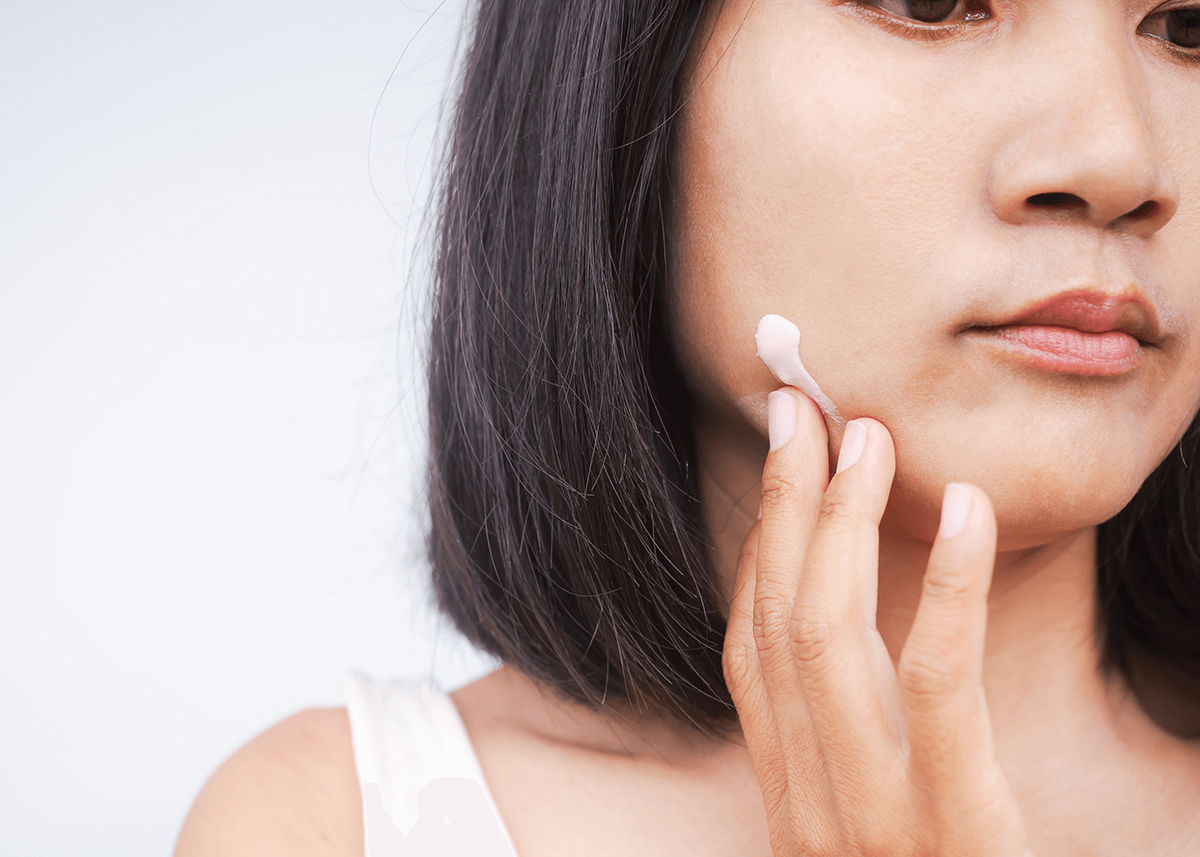 Woman Applying Moisturizer to Side of Face