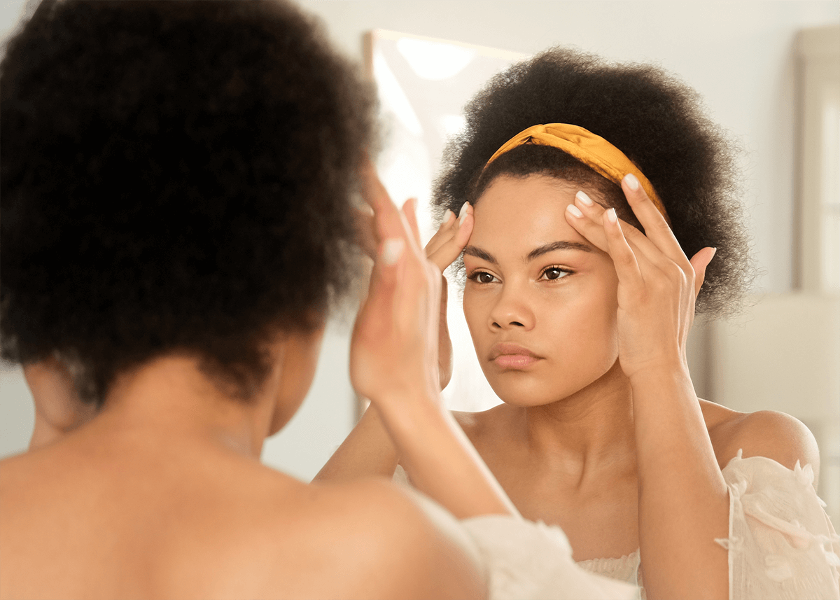 Woman Looking in Mirror for Dry Makeup