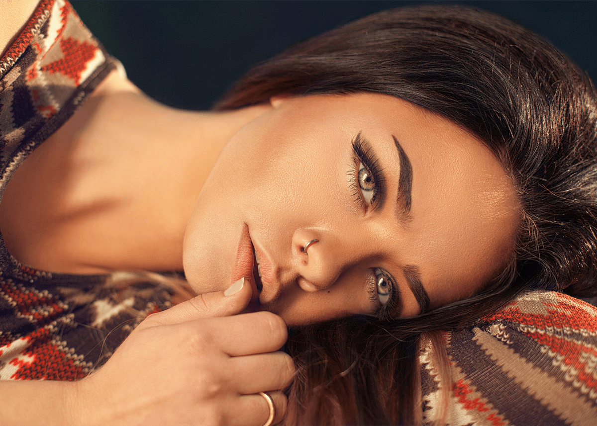 Woman with Contour Makeup Laying Down Radiant Skin