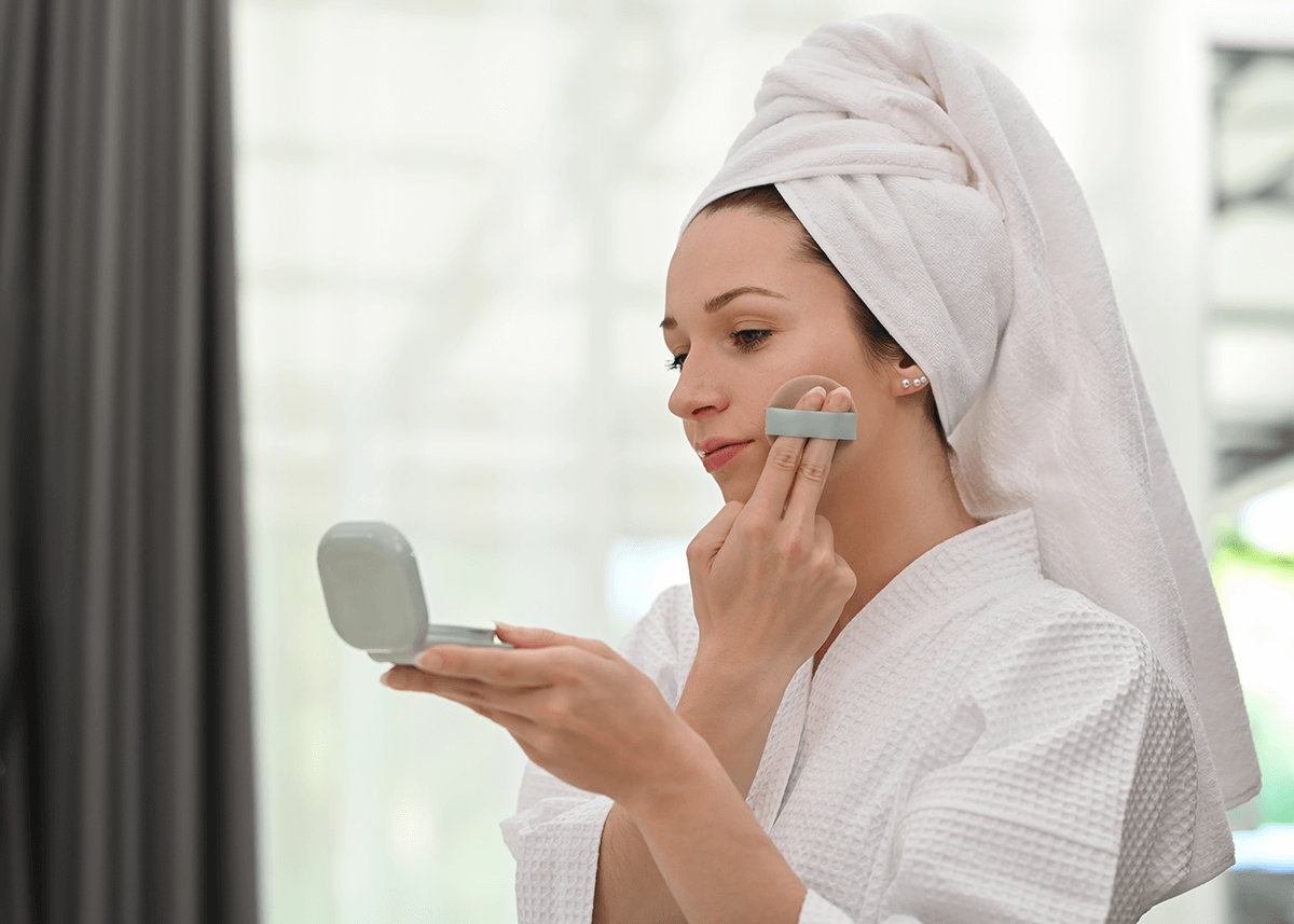 Girl using beauty cushion to apply foundation