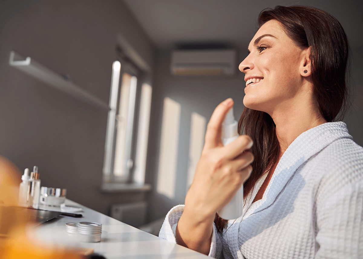 Longhaired woman preparing skin for makeup