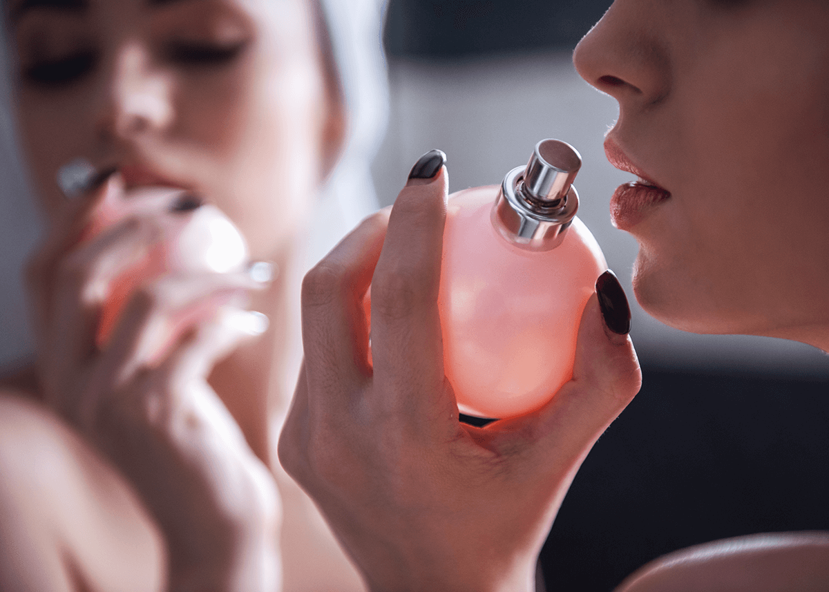 dramatic posing of woman smelling perfume