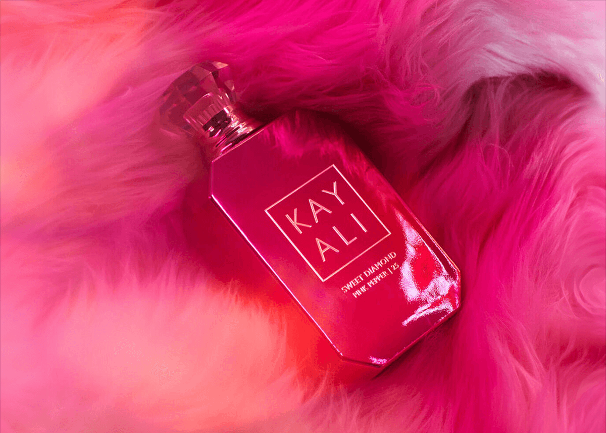 Kayali pink pepper perfume on fur background