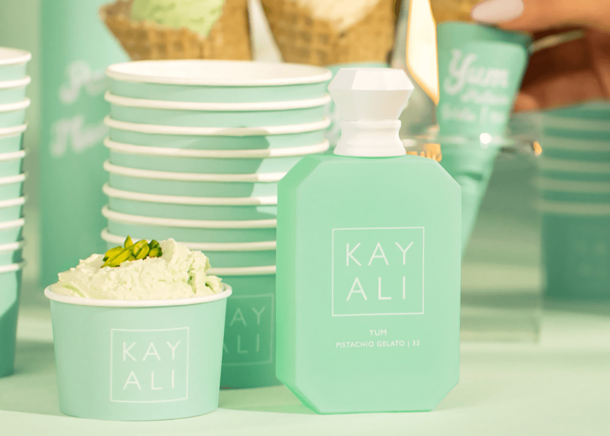 Kayali pistachio fragrance on table with gelato and branded cups