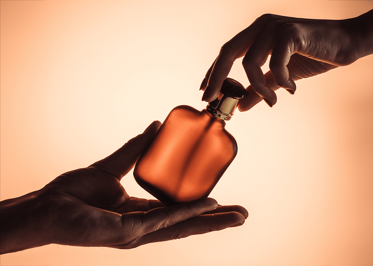 male and female hands on perfume gender equality