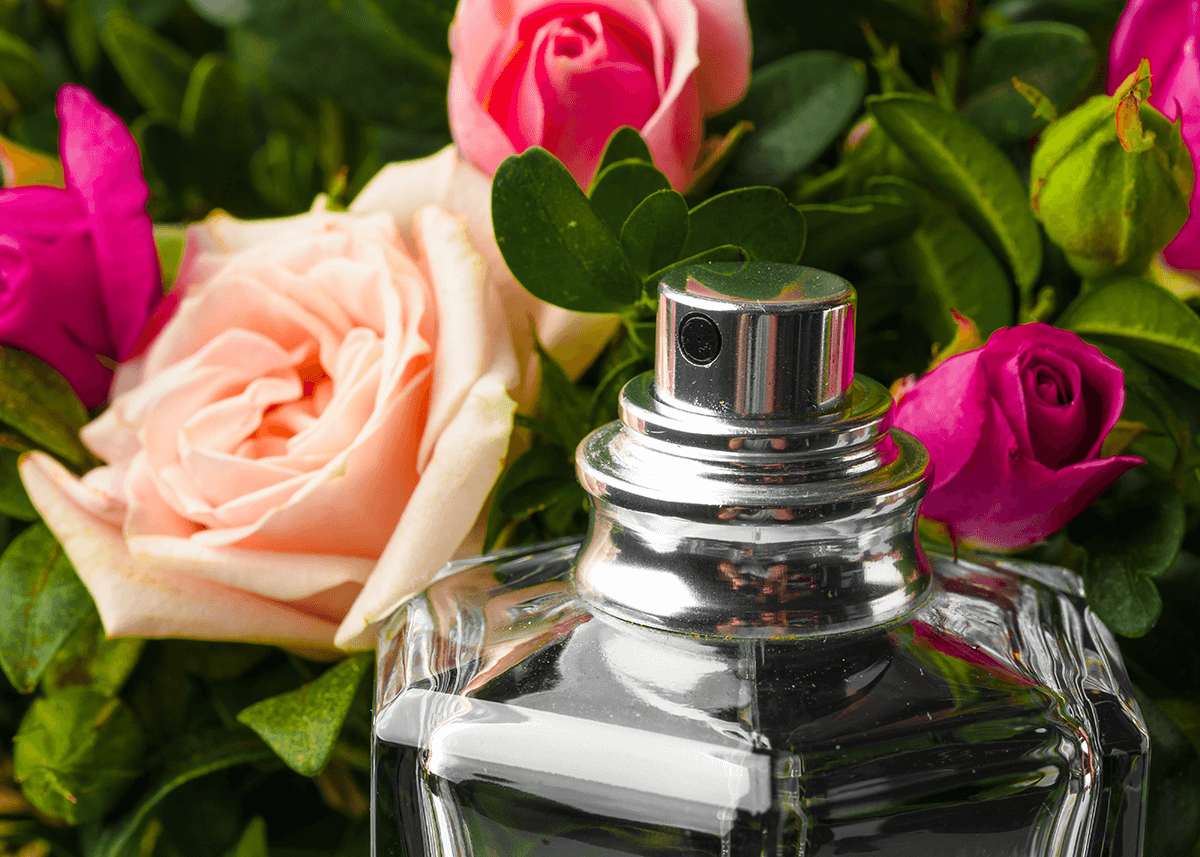 perfume bottle in front of roses