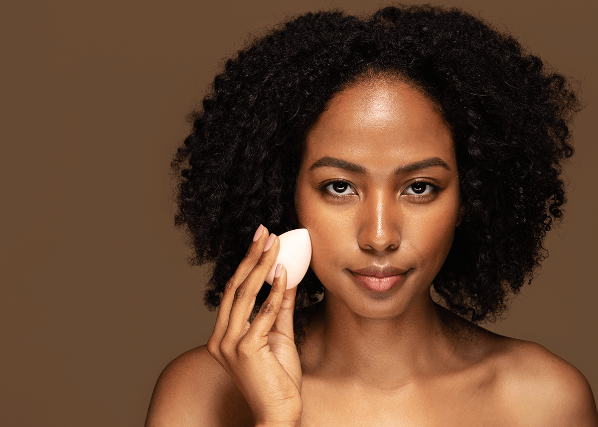 Girl using beauty sponge foundation