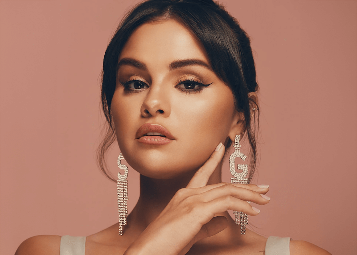 selena gomez posing with under eye brightener rare beauty