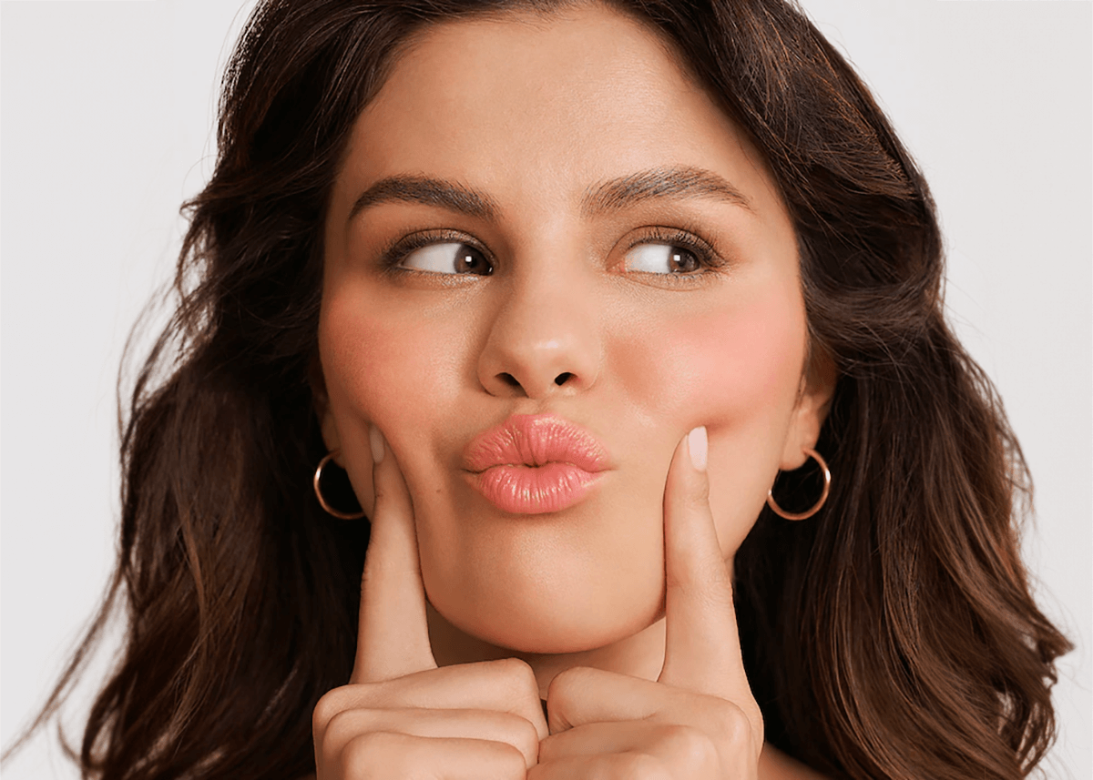 selena gomez posing with lip balm