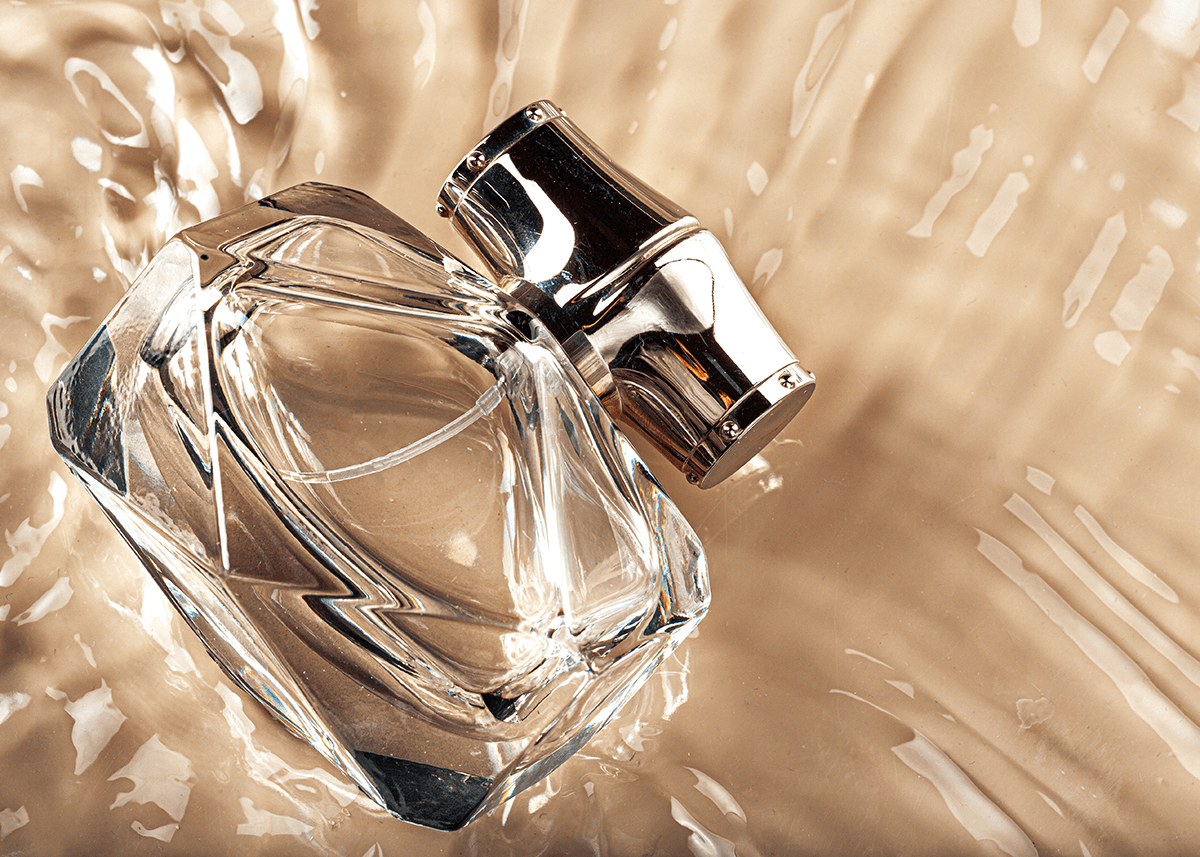 small bottle of perfume laying in water