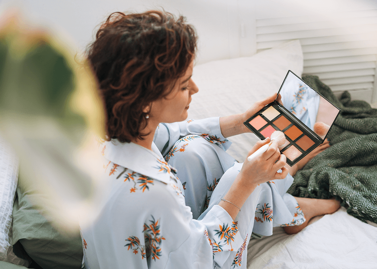 Girl looking through nude eyeshadow palette