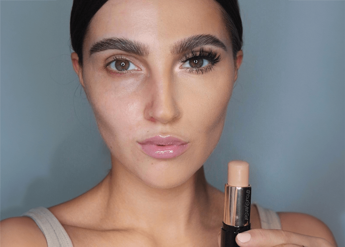 Woman using stick foundation half applied